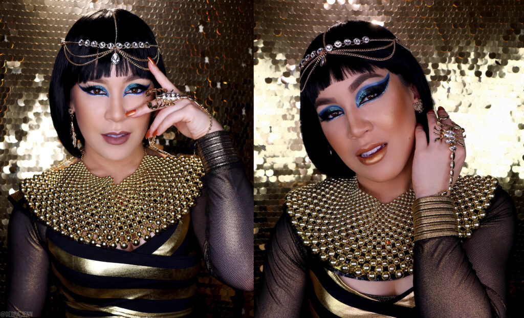 cleopatra makeup with blue eyeshadow and big gold necklace, scorpion bracelet, and gold head piece