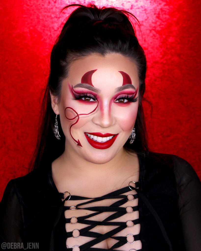easy devil makeup with devil horns above eyebrows and devil tail drawn on face