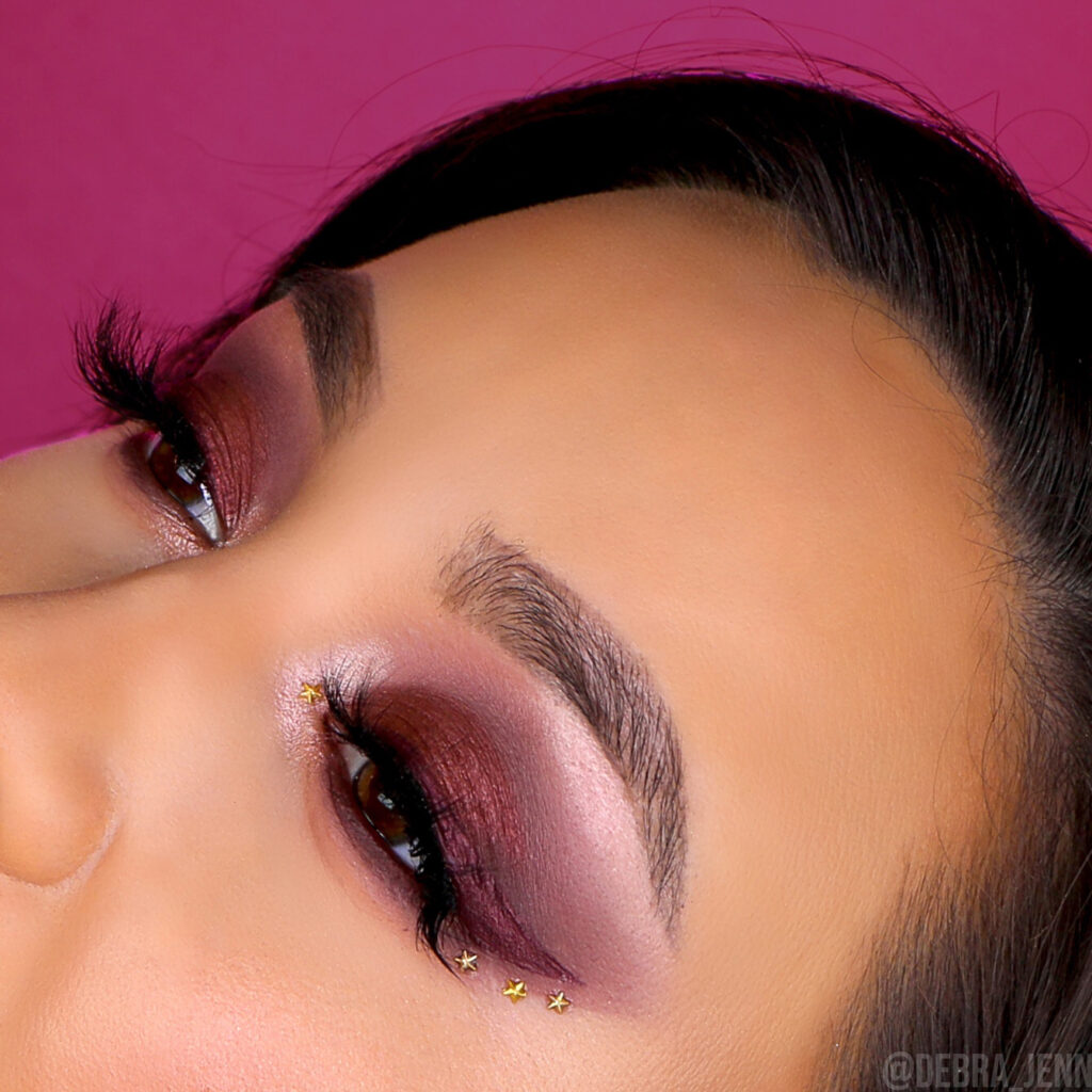 A closeup of Debra Jenn's burgundy eyeshadow with berry winged eyeliner