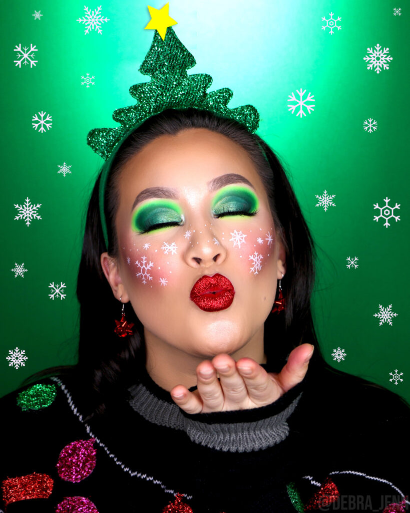 Debra Jenn in Snowflake makeup look with green eyeshadow and red glitter lips for Christmas