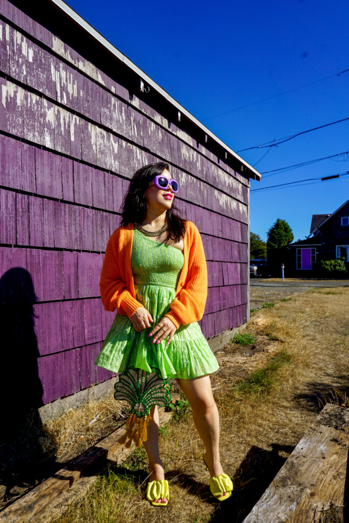 cute summer outfit ideas - green sundress with color blocking accessories, orange sweater, raffia bag, and yellow sandals