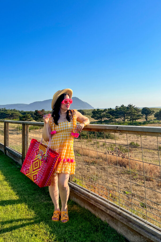 cute summer outfit ideas - yellow sundress with pink beach bag, oversized sunglasses, and straw boater hat